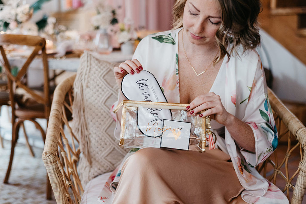 Bridesmaid opening her bachelorette party gift