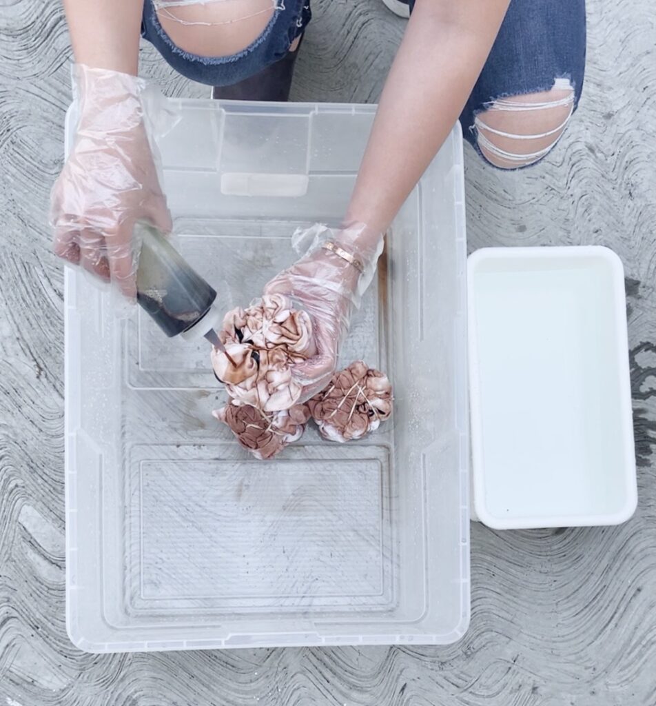 Action shot of girl tie dying a shirt 