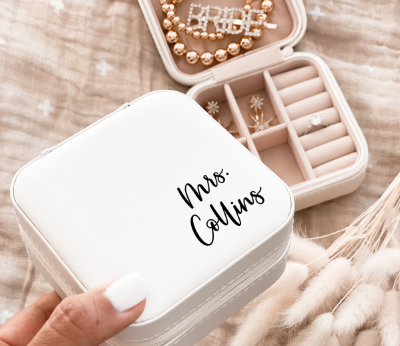 Discover the perfect gift for the bride with our personalized white jewelry box, a must-have in gifts for the bride. This elegant and customized box features her new last name, providing a sentimental and secure place for her cherished jewelry pieces.