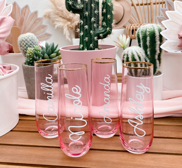 Personalized pink champagne flutes with elegant gold rims, adding a touch of sophistication and charm.