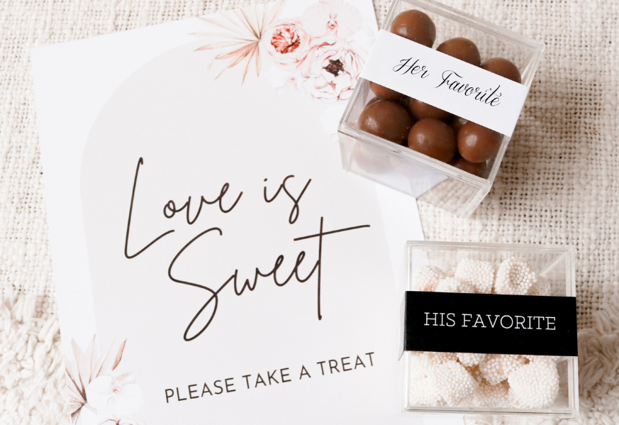 His & Hers candy box wedding favors with a "Love is Sweet: Please Take a Treat" banner.